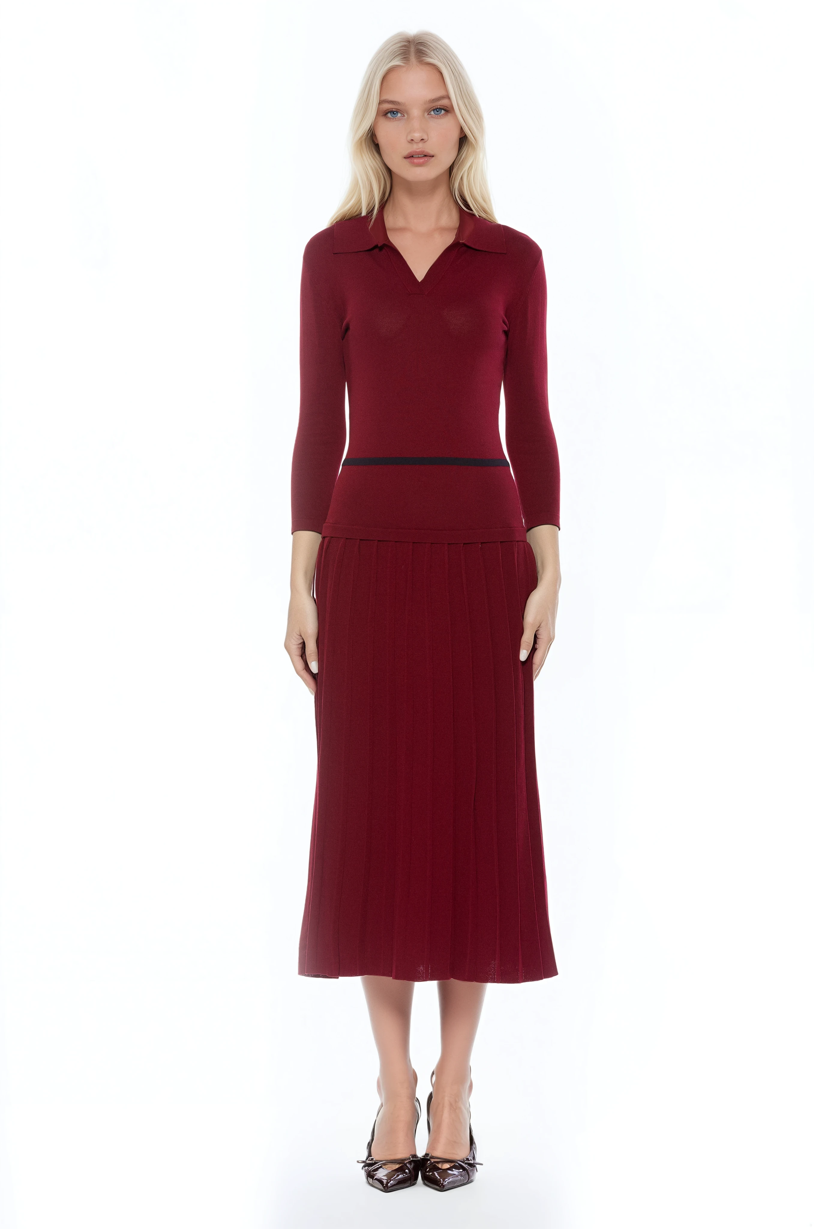 Front view burgundy knit midi dress with drop waist, contrast black detail, pleated bottom, knit collar and 3/4 sleeves.