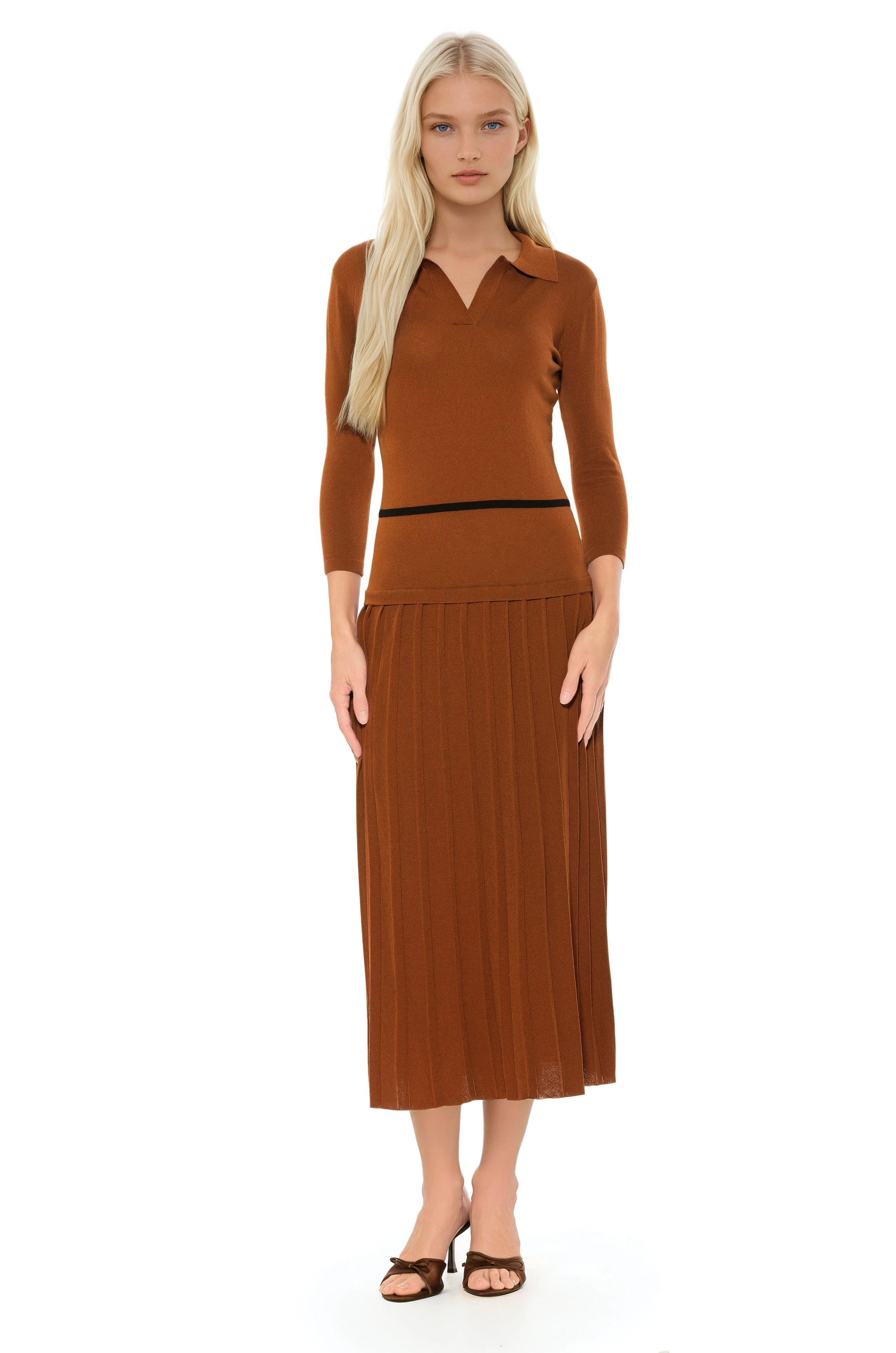 Front view camel knit midi dress with drop waist, contrast black detail, pleated bottom, knit collar and 3/4 sleeves.
