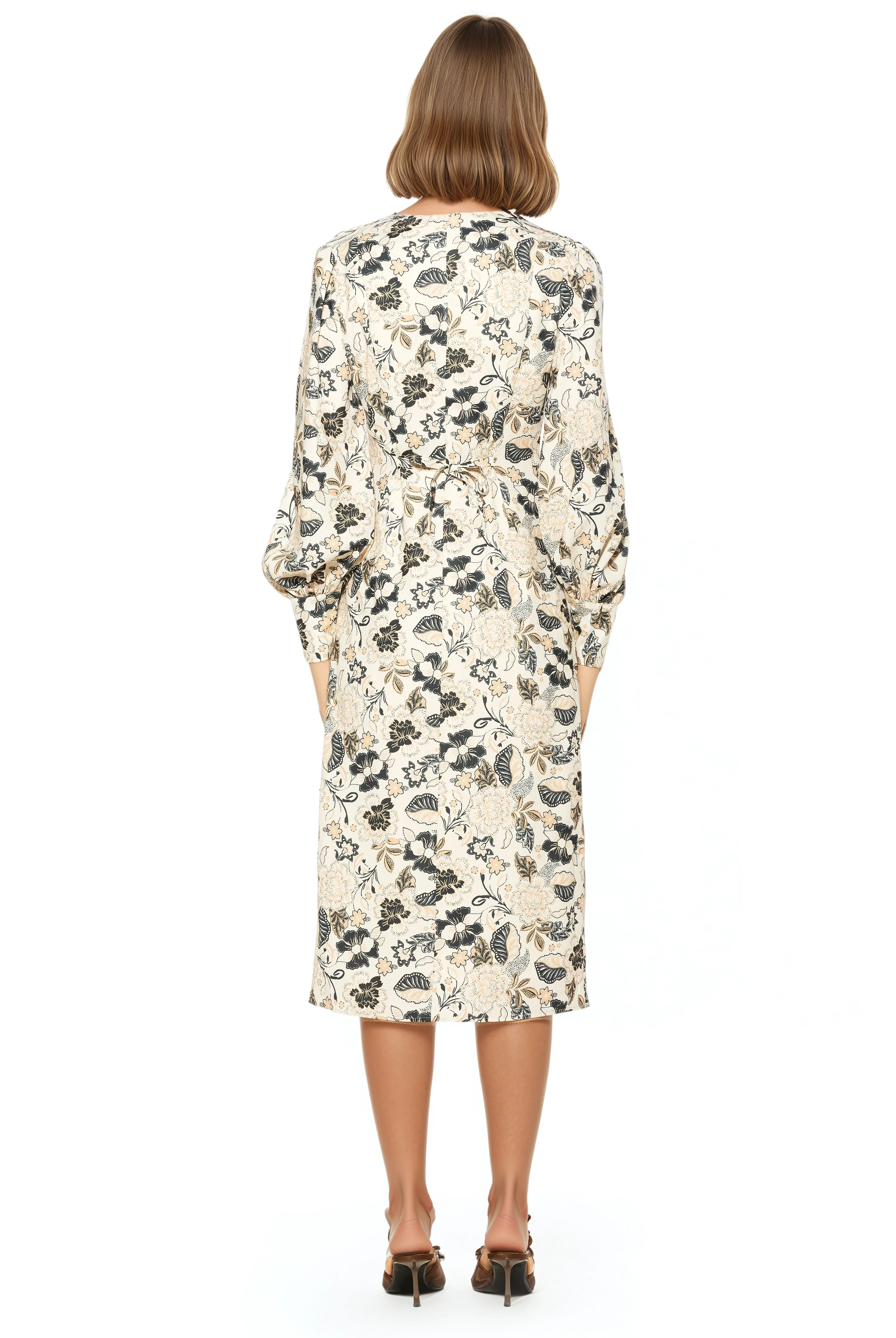 Back view ivory paisley print midi dress adjustable tie back, blouson sleeves with button cuffs.