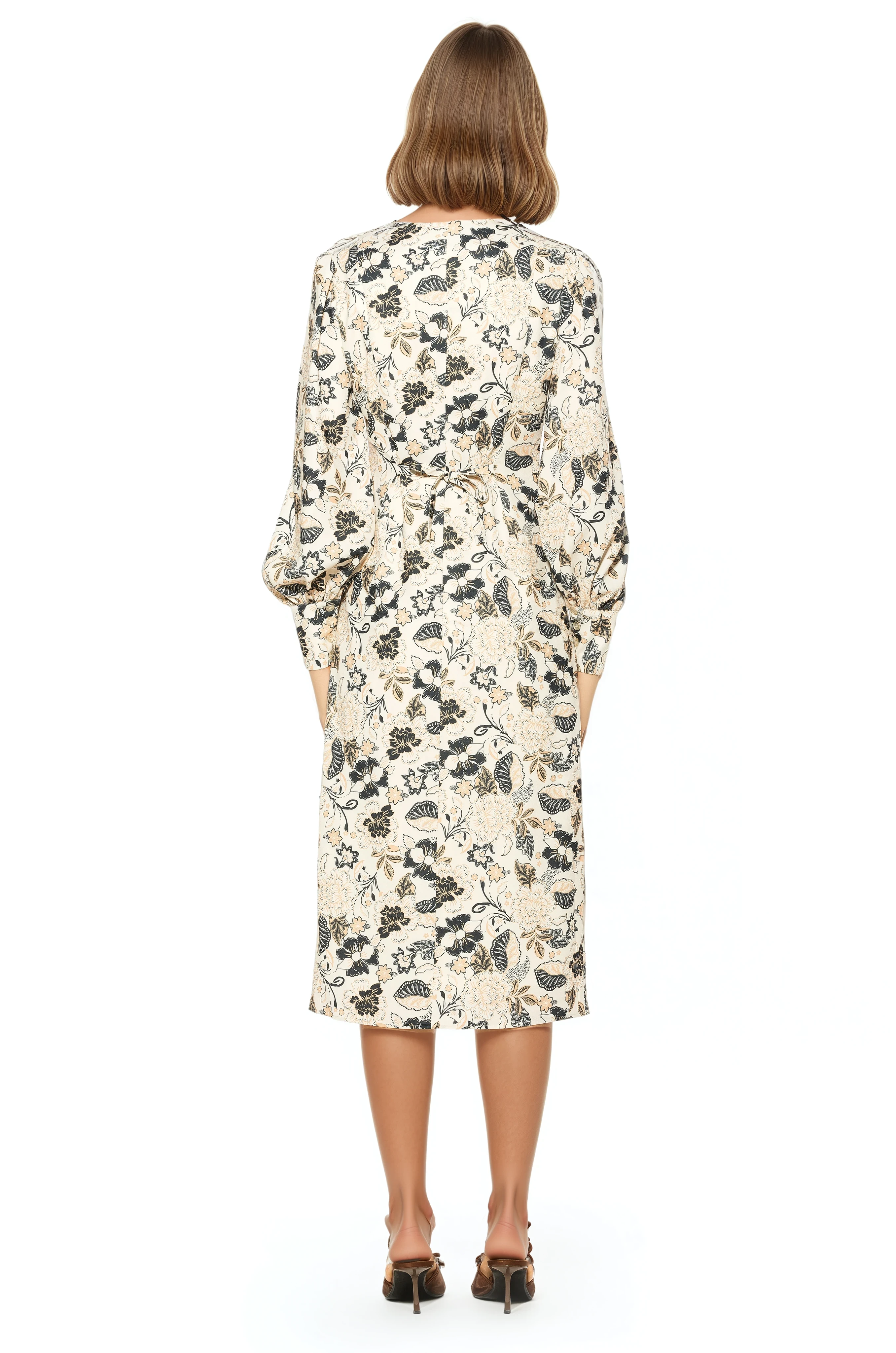 Back view ivory paisley print midi dress adjustable tie back, blouson sleeves with button cuffs.