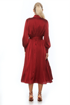 Back view burgundy maxi dress, long sleeve, blouson sleeves with wide cuffs, belted.