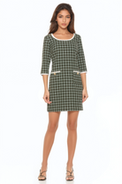 Front view green plaid mini dress, scoop neck, 3/4 sleeve, contrast ivory binding and gold buttons at pockets.