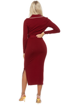 Back view burgundy midi dress, long sleeves, surplice neck, black contract detail, side slit.