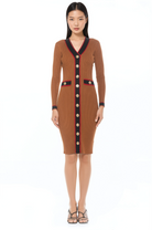 Front view camel v-neck knit dress, long sleeves, contrast black and red trim with gold button detailing.