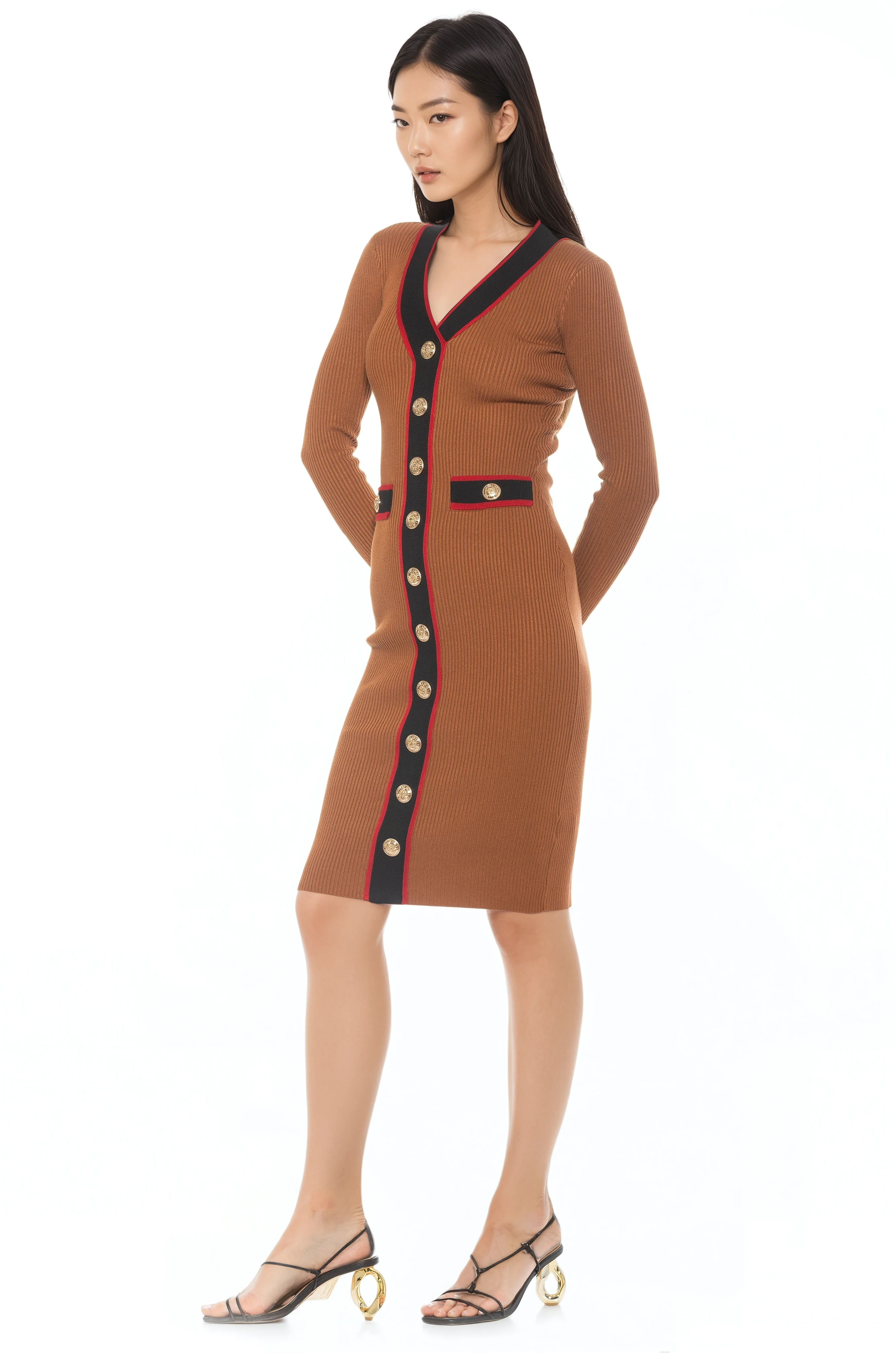 Side view camel v-neck knit dress, long sleeves, contrast black and red trim with gold button detailing.