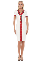 Front view ivory v-neck knit dress, short sleeve, contrast red and navy trim with gold button detailing.