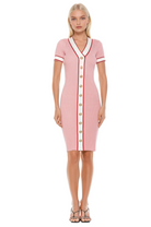 Front view pink v-neck knit dress, short sleeve, contrast ivory and red trim with gold button detailing.