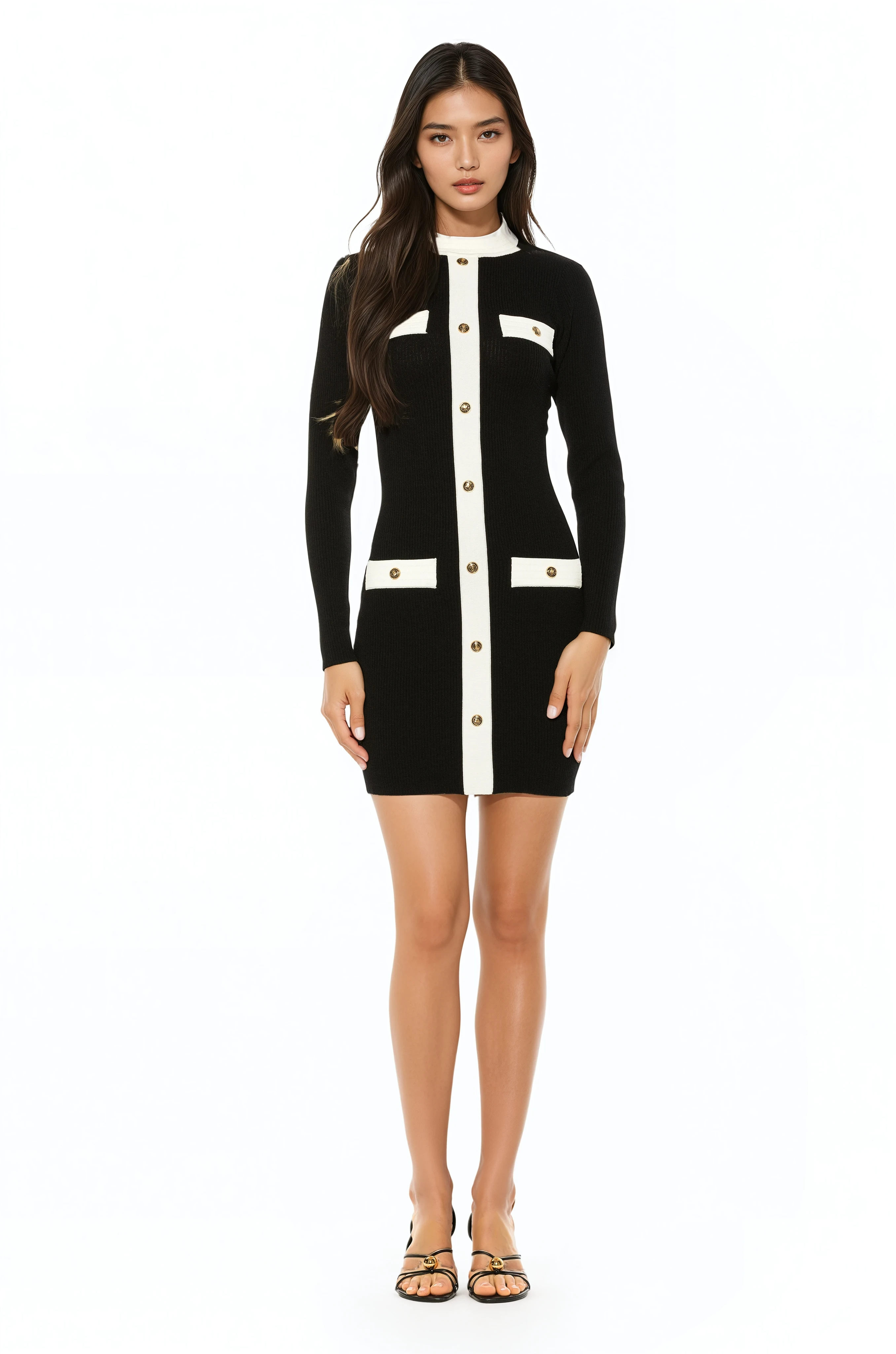 Front view black long sleeve knit mini dress, crew neck with white contrast detail and mock gold snap buttons.