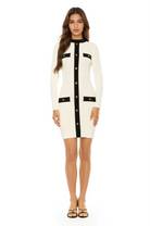 Front view ivory long sleeve knit mini dress, crew neck with black contrast detail and mock gold snap buttons.