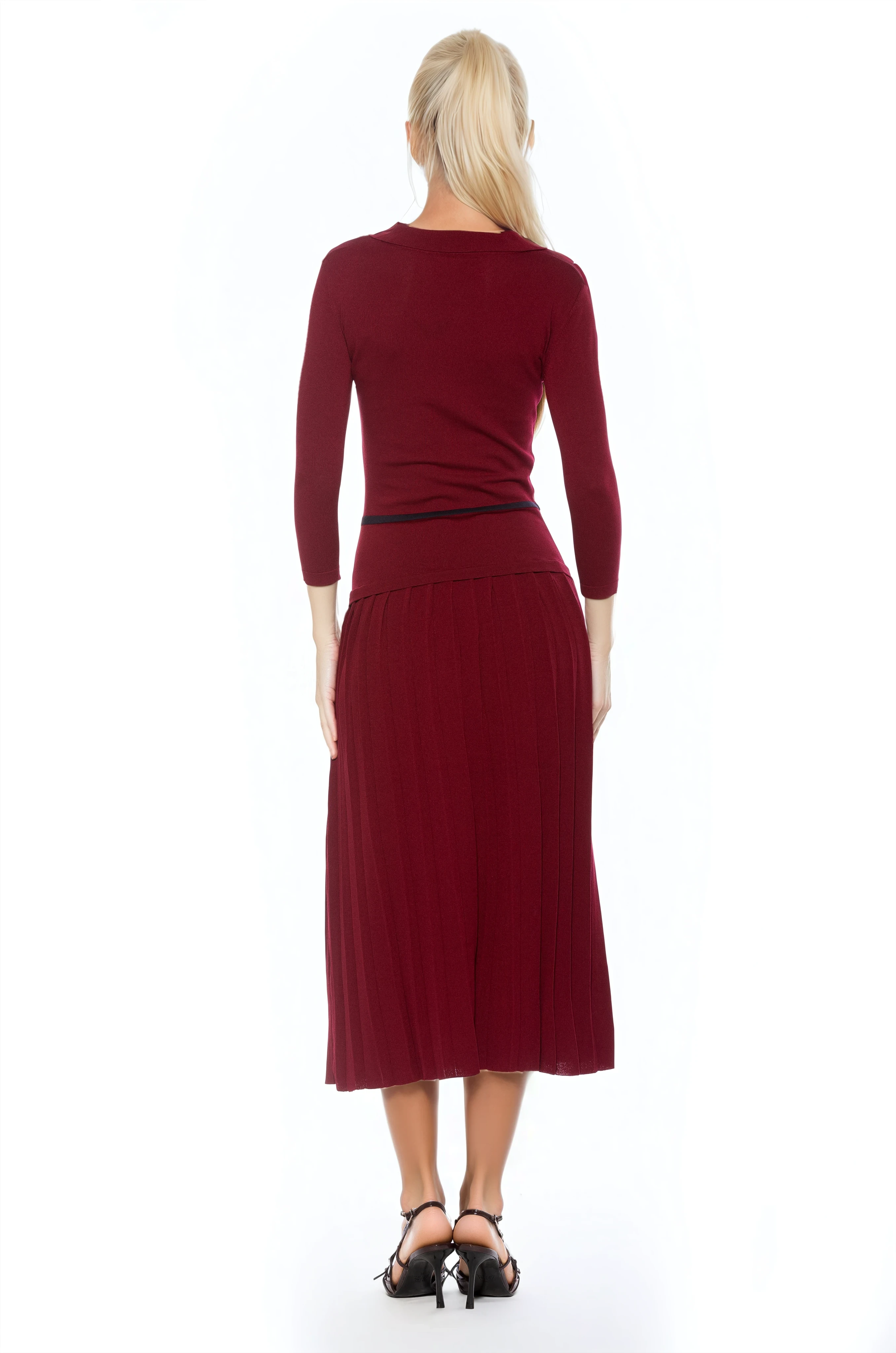 Back view burgundy knit  midi dress with drop waist, contrast black detail, pleated bottom, knit collar and 3/4 sleeves.