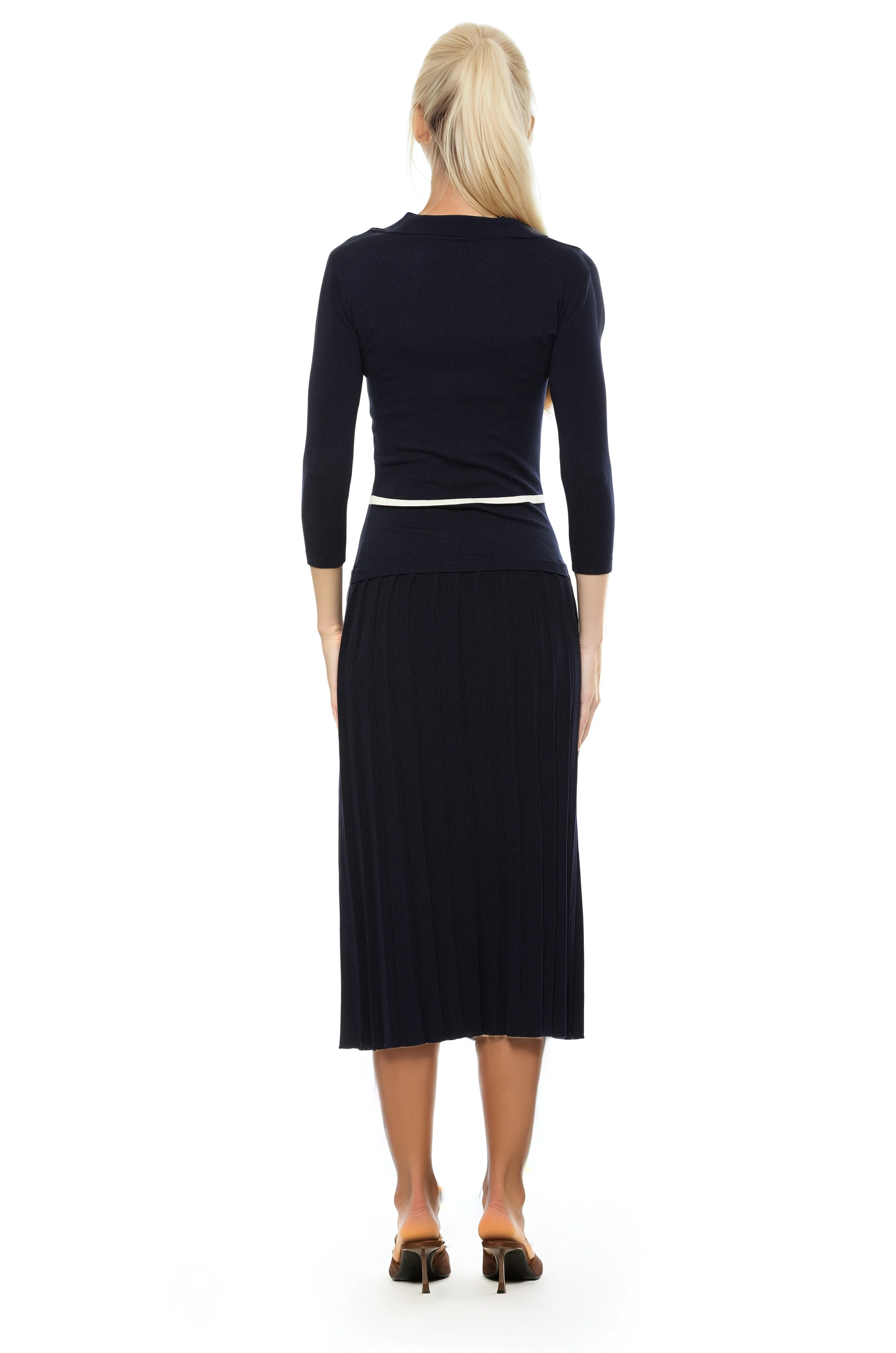 Back view black knit  midi dress with drop waist, contrast white detail, pleated bottom, knit collar and 3/4 sleeves.