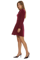 Side view burgundy fit and flare mini dress, knit, long sleeve collar neckline with gold buttons.