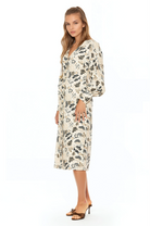 Side view ivory paisley print midi dress with v-neck, button front, blouson sleeves with button cuffs.