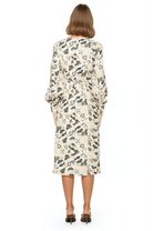 Back view ivory paisley print midi dress adjustable tie back, blouson sleeves with button cuffs.