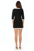 Back view black tweed mini shift dress,  3/4 sleeve, ivory contrast hems.