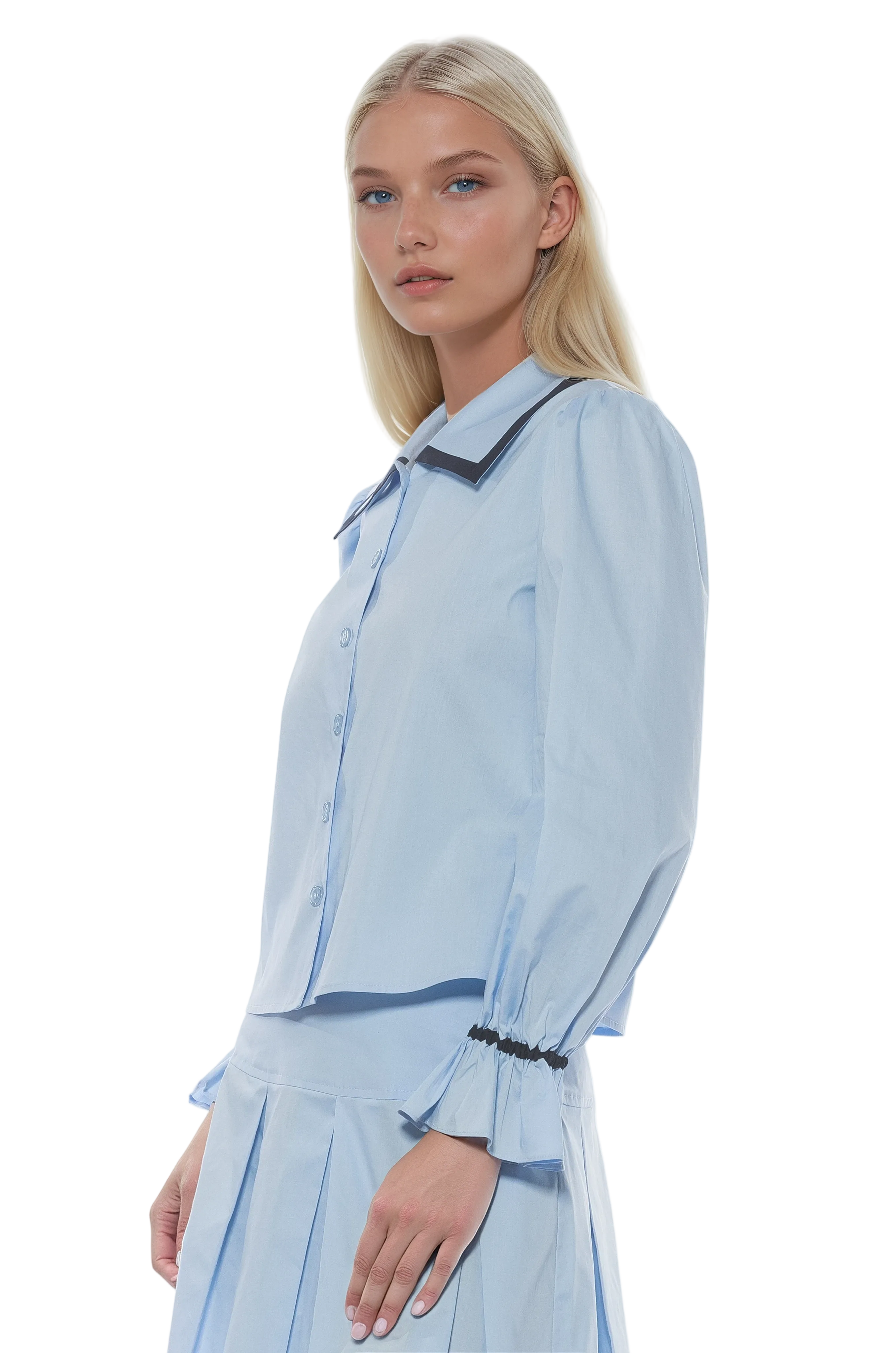 Side view blue button front blouse with black contrast detail on collar and cuffs and blouson sleeves.