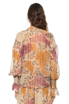 Back view paisley print ruffle blouse, shirt tail hem, blouson sleeve with smocked ruffle cuff.
