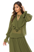 Front view green ruffle blouse, v-neck front neck tie, blouson sleeve with smocked ruffle cuff.
